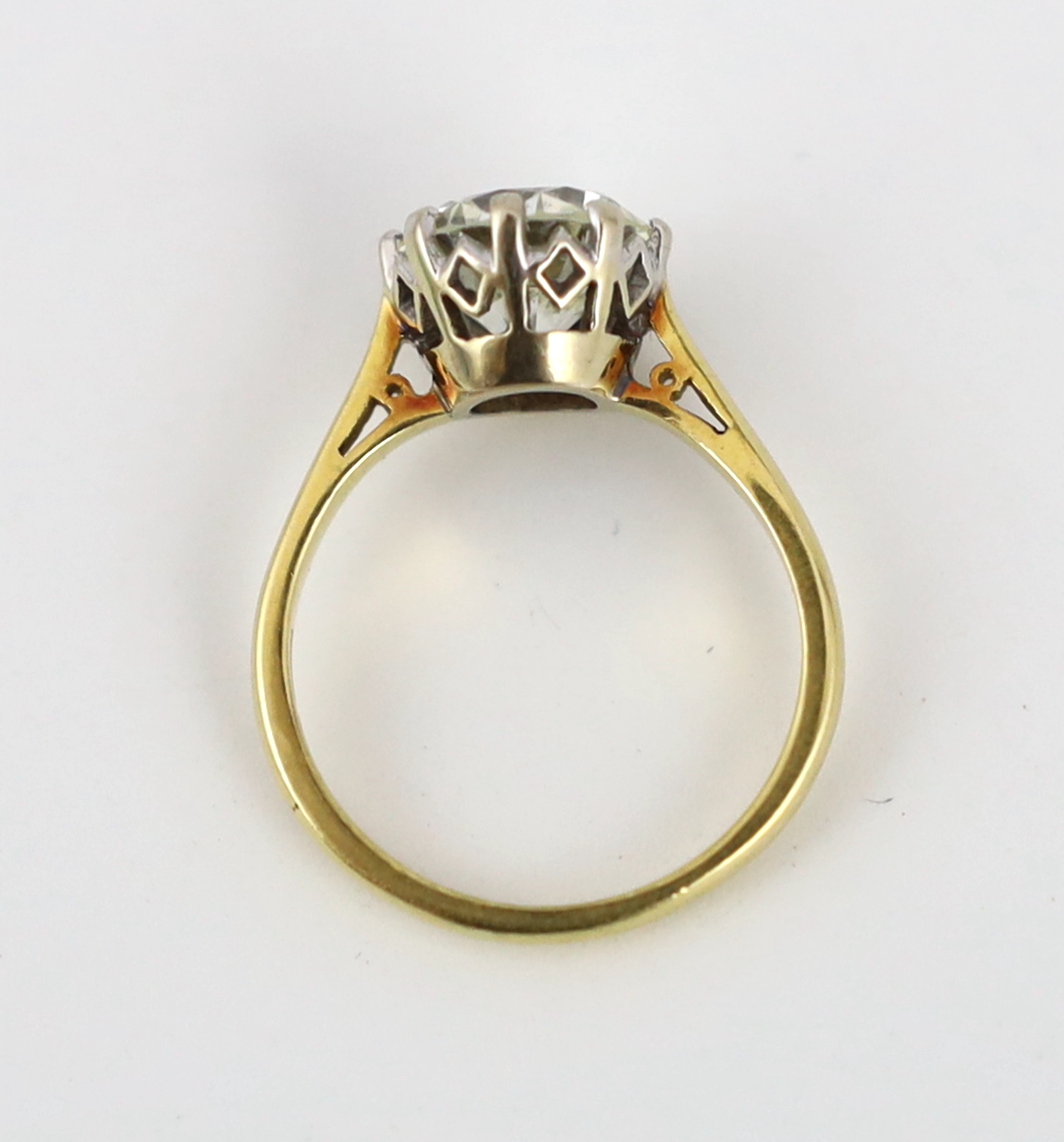 A modern 18ct gold and solitaire diamond set ring